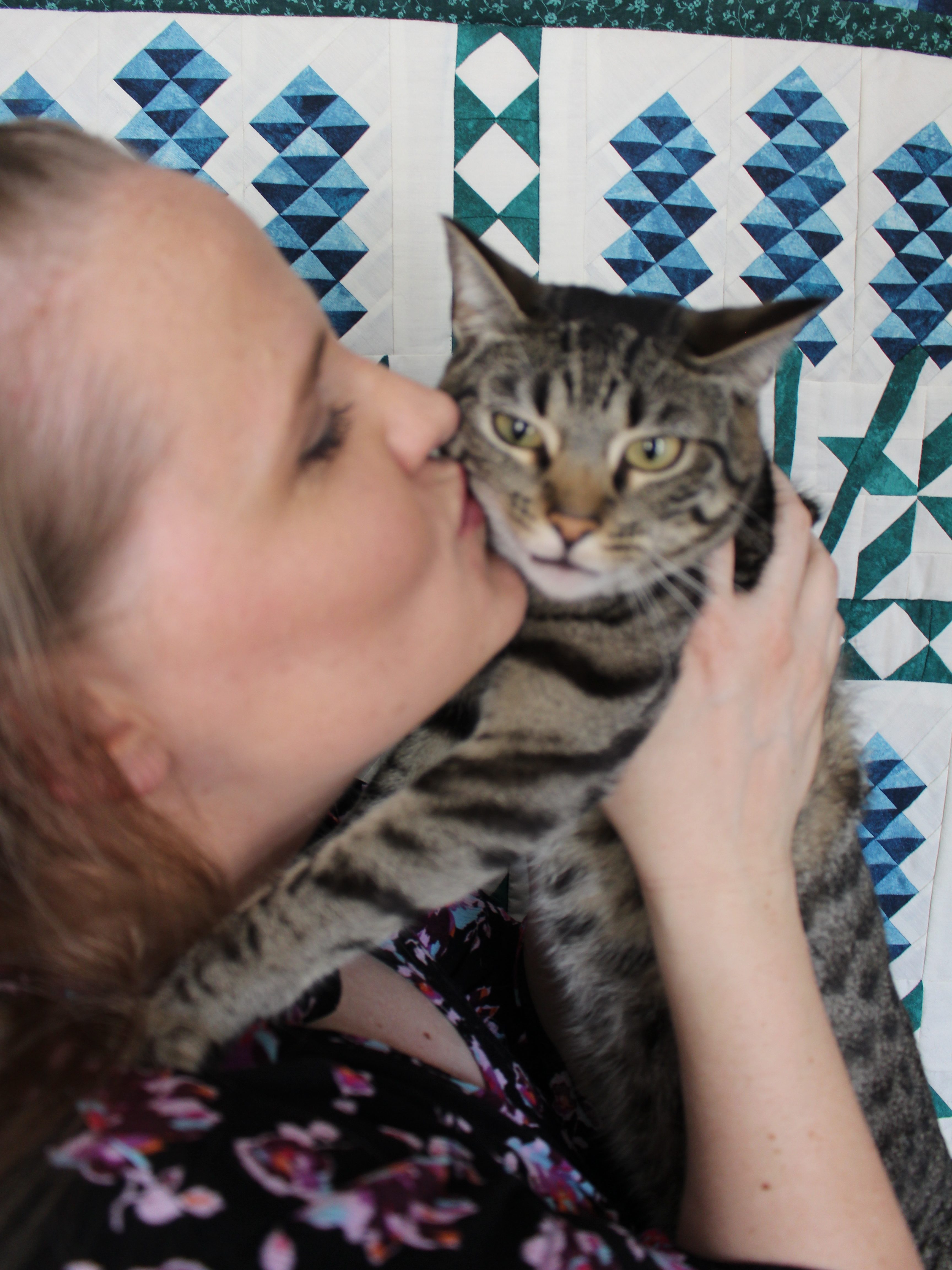 Me kissing a very frustrated Princess Jasmine in front of the Bluebonnets quilt my mother and I made.